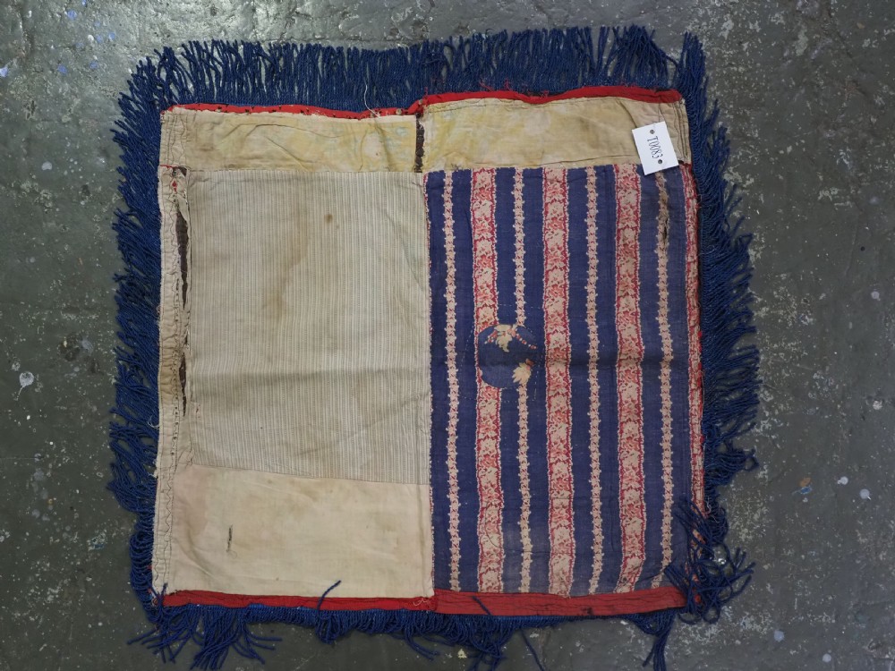 A square antique Uzbek Lakai embroidered panel featuring colourful silk floral motifs on a dark velvet ground, trimmed with a blue fringed border. View VIII