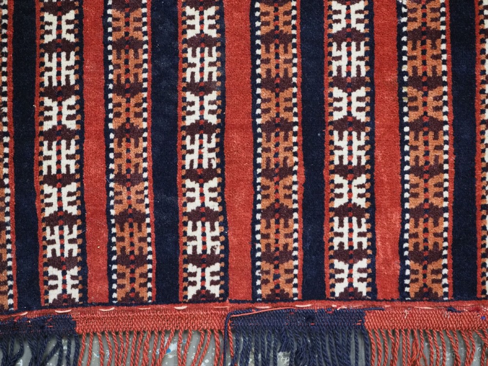 Hand-woven red, dark navy, and ivory striped Turkmen wool horse cover featuring geometric motifs and fringe along the lower edges. View XII