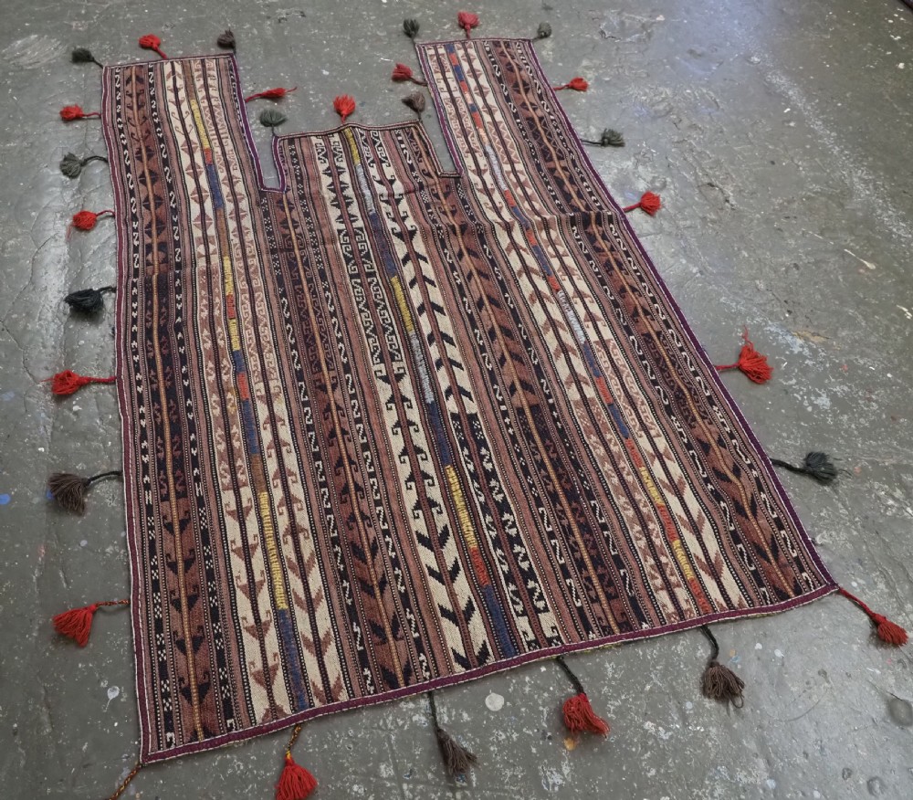 A flat-weave woven wool Northern Afghan ceremonial horse blanket featuring brown, cream, red, and blue geometric stripes with wool tassels along the edges. View II