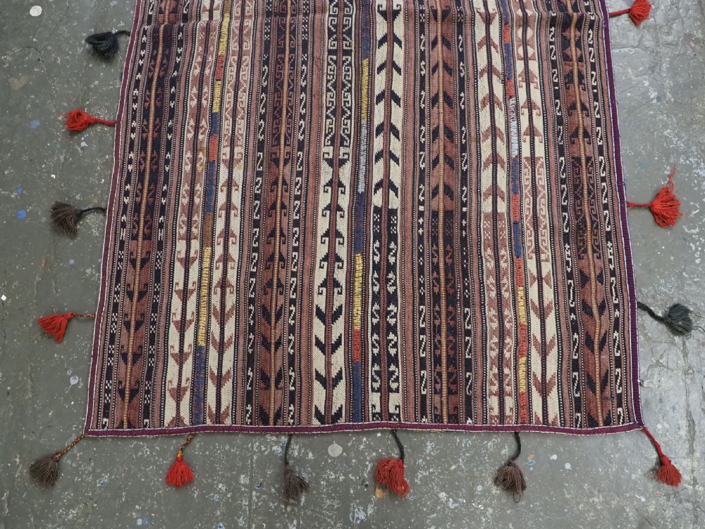 A flat-weave woven wool Northern Afghan ceremonial horse blanket featuring brown, cream, red, and blue geometric stripes with wool tassels along the edges. View IV