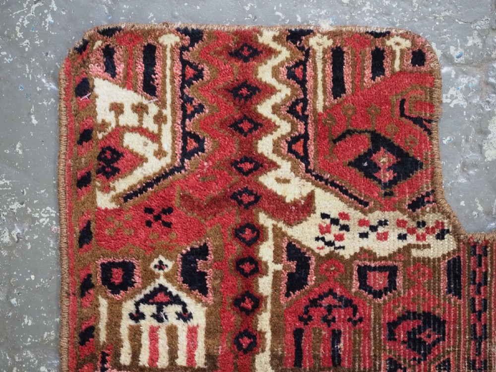 A late nineteenth-century Ersari Beshir Turkmen saddle rug featuring red, cream, and dark navy geometric patterns with a central top notch. View III