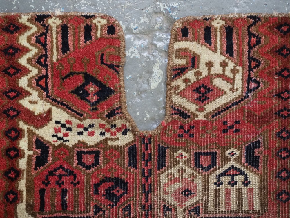 A late nineteenth-century Ersari Beshir Turkmen saddle rug featuring red, cream, and dark navy geometric patterns with a central top notch. View IV