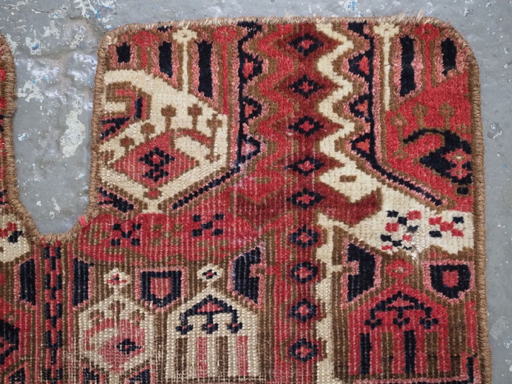 A late nineteenth-century Ersari Beshir Turkmen saddle rug featuring red, cream, and dark navy geometric patterns with a central top notch. View V