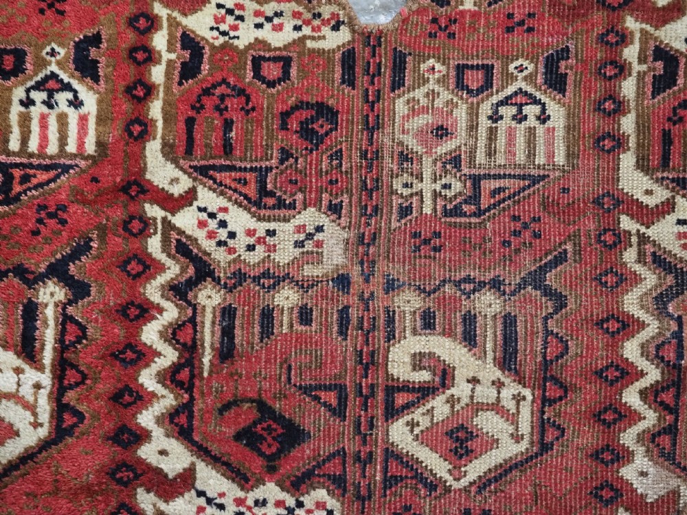 A late nineteenth-century Ersari Beshir Turkmen saddle rug featuring red, cream, and dark navy geometric patterns with a central top notch. View VI