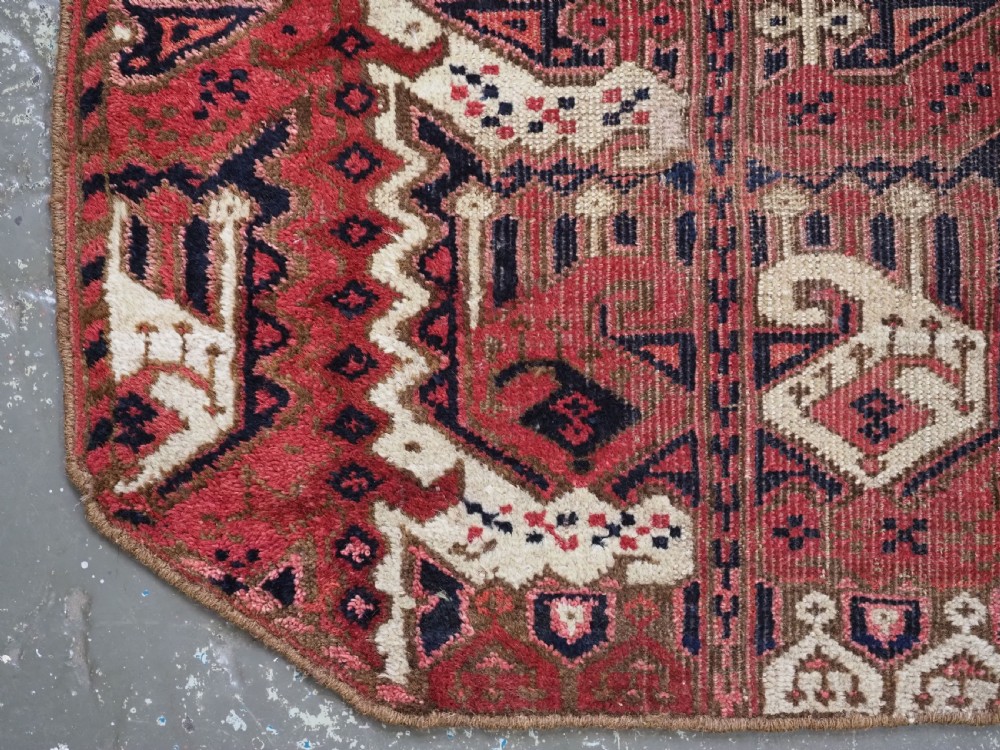 A late nineteenth-century Ersari Beshir Turkmen saddle rug featuring red, cream, and dark navy geometric patterns with a central top notch. View VII