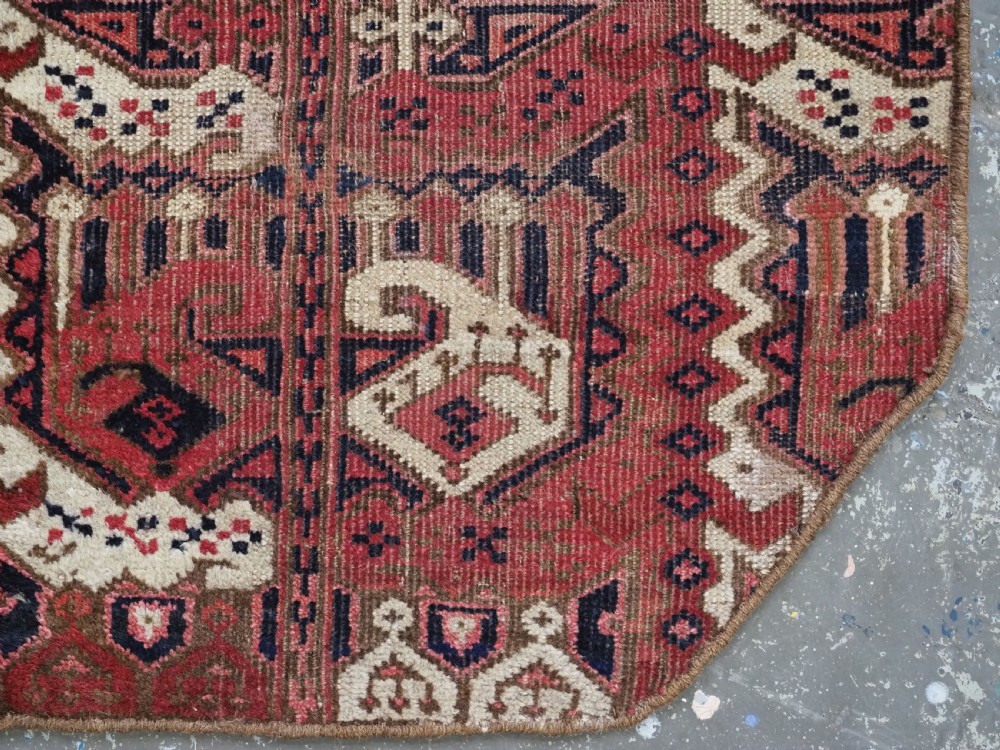 A late nineteenth-century Ersari Beshir Turkmen saddle rug featuring red, cream, and dark navy geometric patterns with a central top notch. View VIII