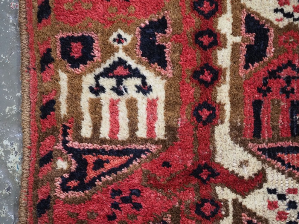 A late nineteenth-century Ersari Beshir Turkmen saddle rug featuring red, cream, and dark navy geometric patterns with a central top notch. View IX