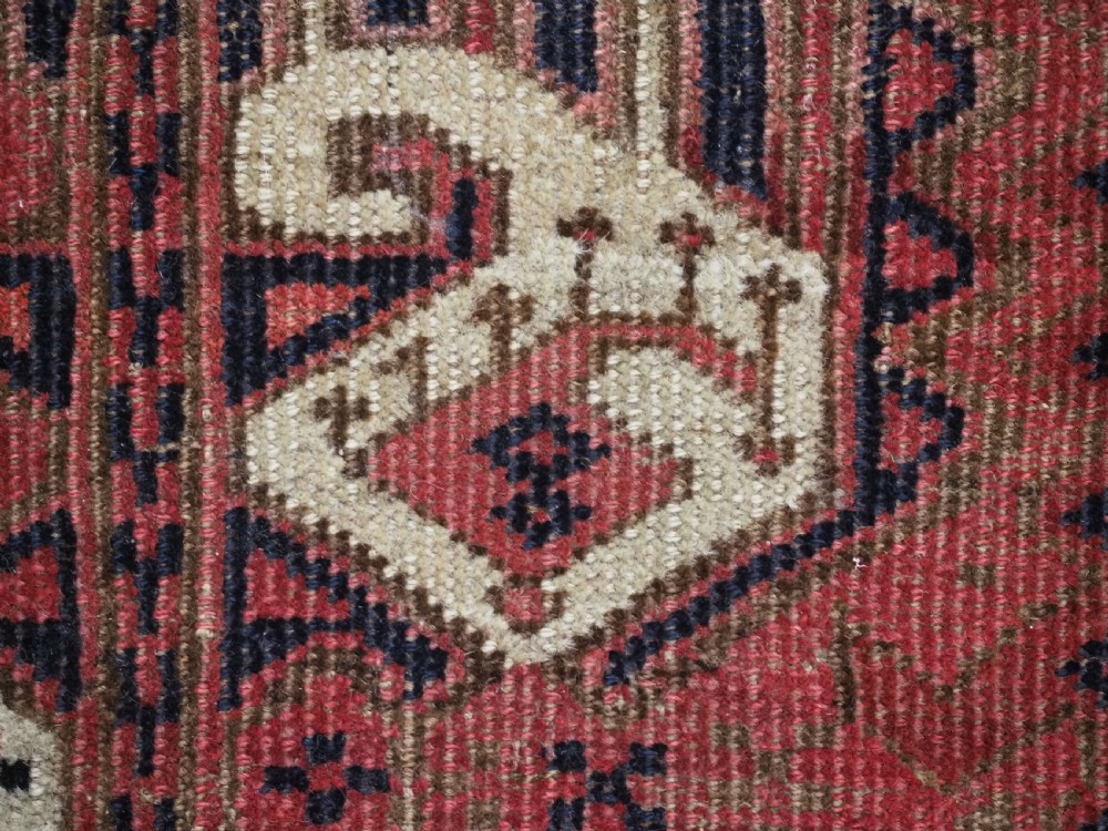 A late nineteenth-century Ersari Beshir Turkmen saddle rug featuring red, cream, and dark navy geometric patterns with a central top notch. View X