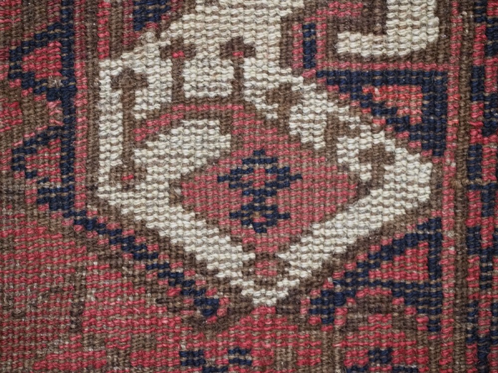 A late nineteenth-century Ersari Beshir Turkmen saddle rug featuring red, cream, and dark navy geometric patterns with a central top notch. View XII