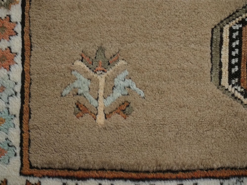 An antique hand-knotted Turkish Konya Karapinar rug featuring a camel wool field and geometric medallions in turquoise and terracotta. View XIII