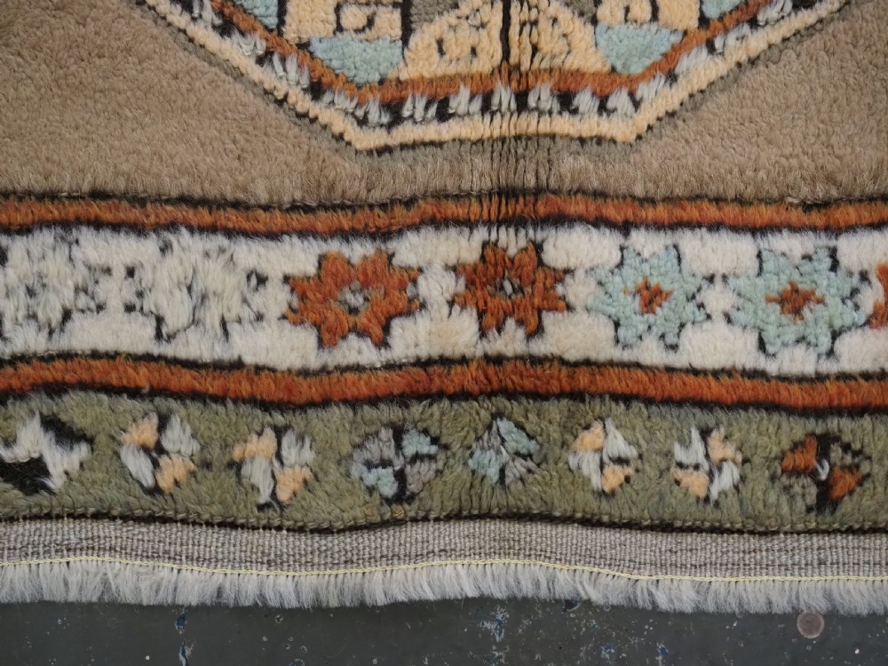 An antique hand-knotted Turkish Konya Karapinar rug featuring a camel wool field and geometric medallions in turquoise and terracotta. View XIV