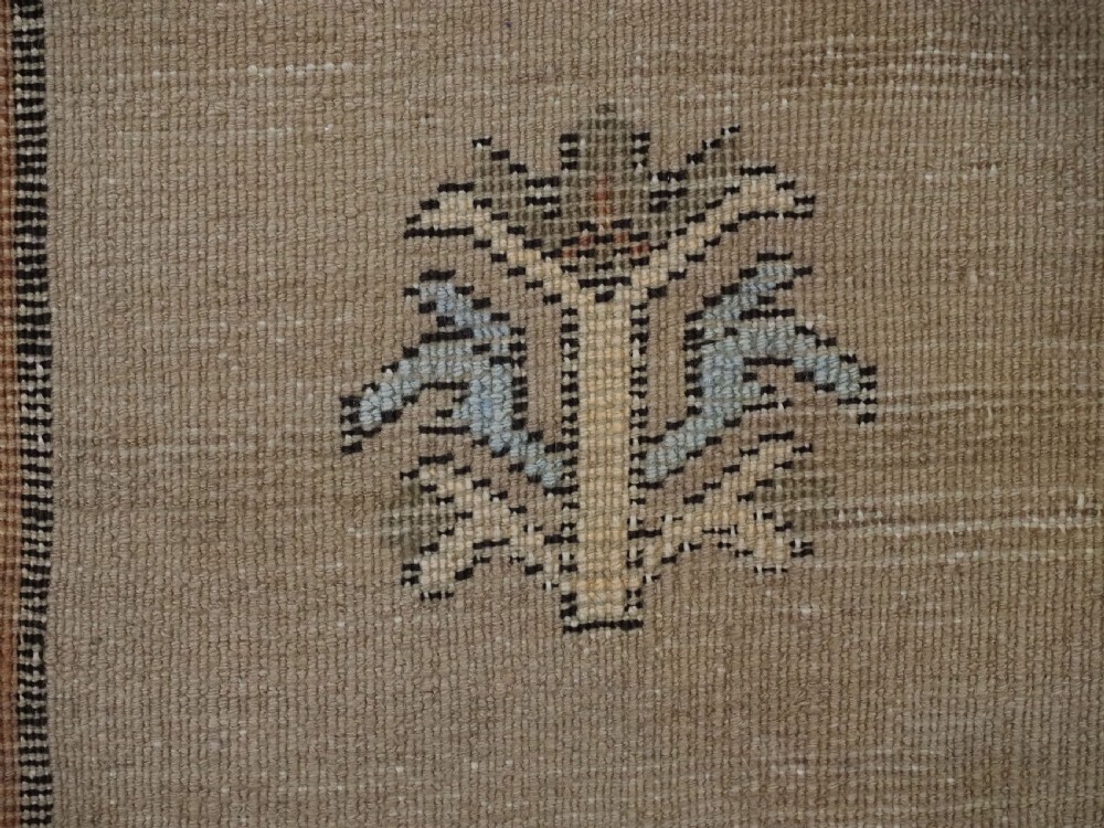 An antique hand-knotted Turkish Konya Karapinar rug featuring a camel wool field and geometric medallions in turquoise and terracotta. View XVI