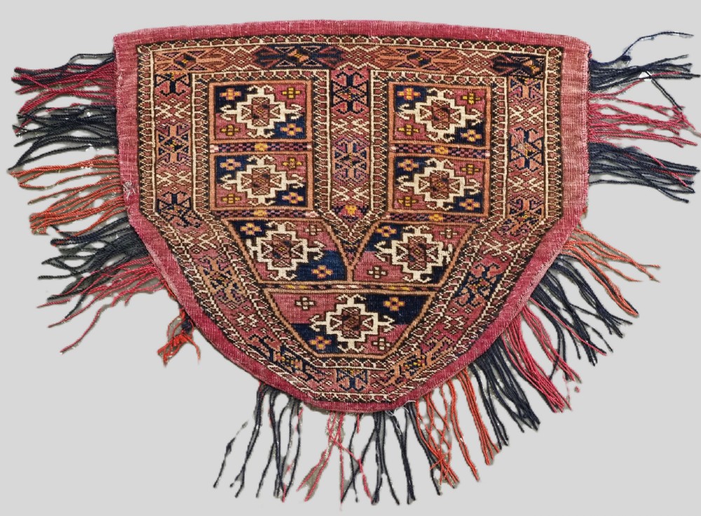 ANTIQUE TEKKE TURKMEN SADDLE COVER / RUG, WITH ORIGINAL TASSELS, CIRCA 1900.