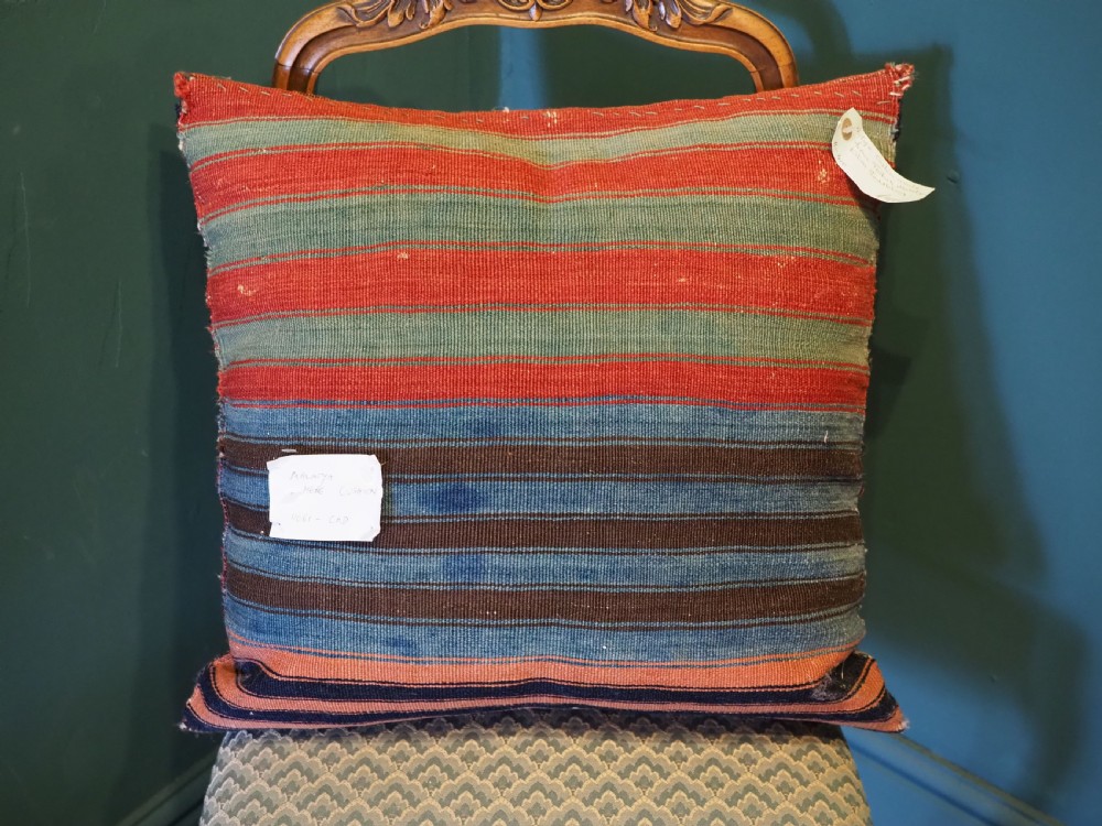 A square hand-woven wool kilim cushion featuring geometric Anatolian patterns in navy blue, off-white, and terracotta. View III