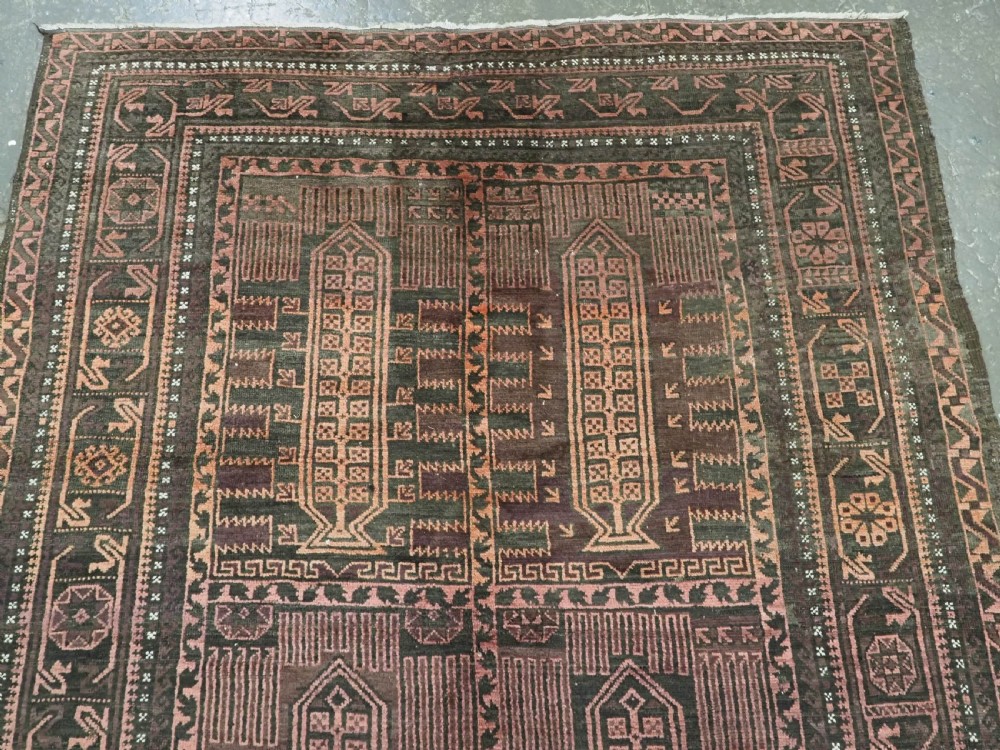 A long, dark-toned hand-knotted wool rug displaying a repeating geometric pencil box motif within complex outer geometric borders. View III