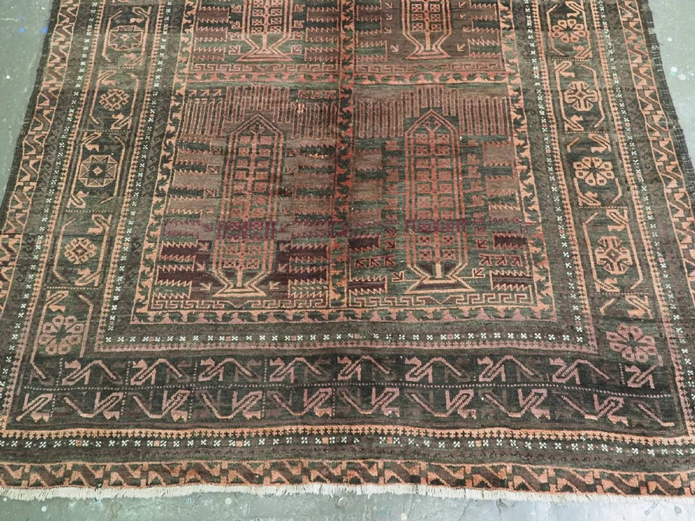 A long, dark-toned hand-knotted wool rug displaying a repeating geometric pencil box motif within complex outer geometric borders. View VI
