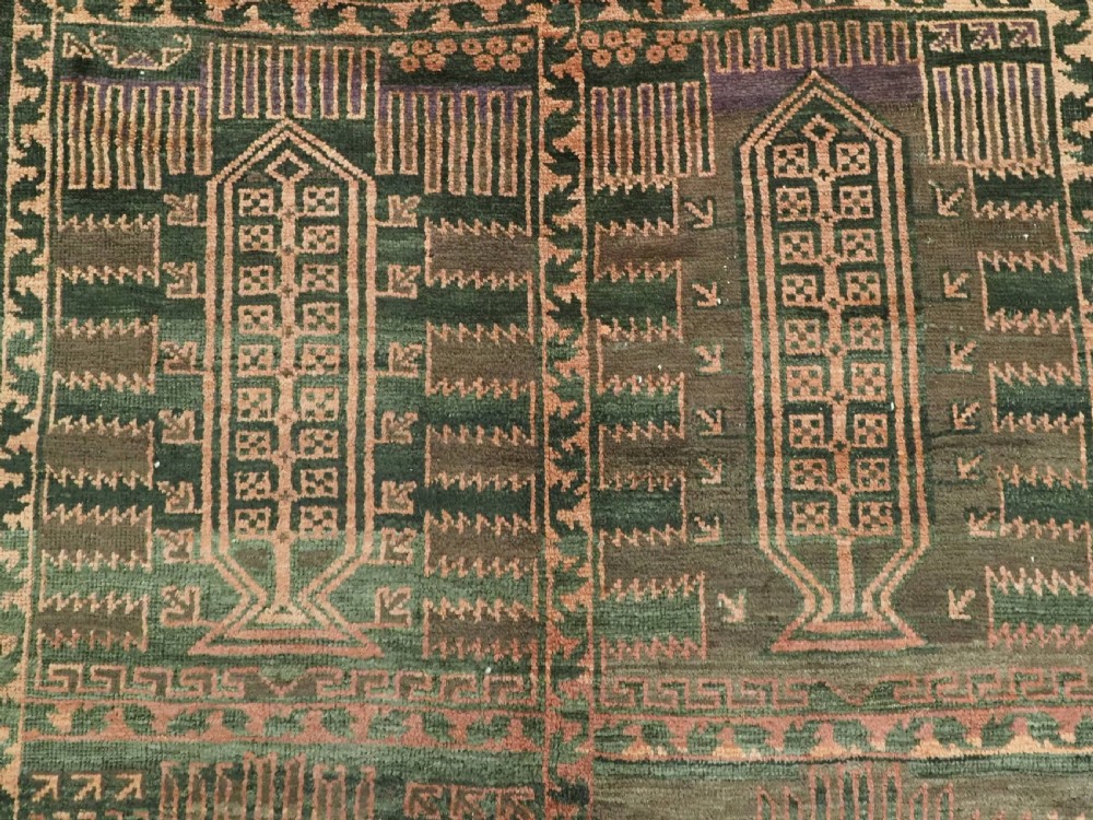 A long, dark-toned hand-knotted wool rug displaying a repeating geometric pencil box motif within complex outer geometric borders. View XI