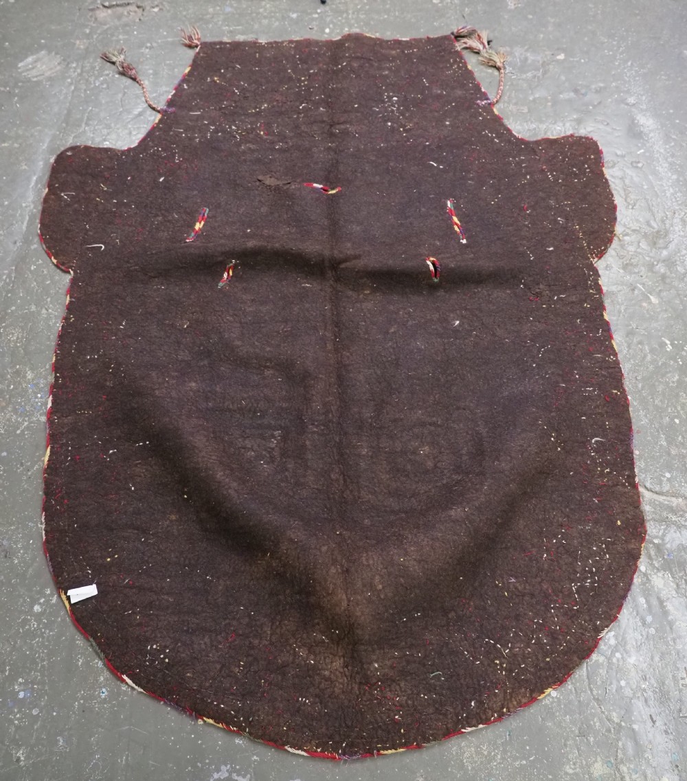 An antique Yomut Turkmen dark brown felt horse blanket featuring intricate red, cream, and green geometric embroidered borders, central spiral scroll motifs, and top corner tassels. View XVI