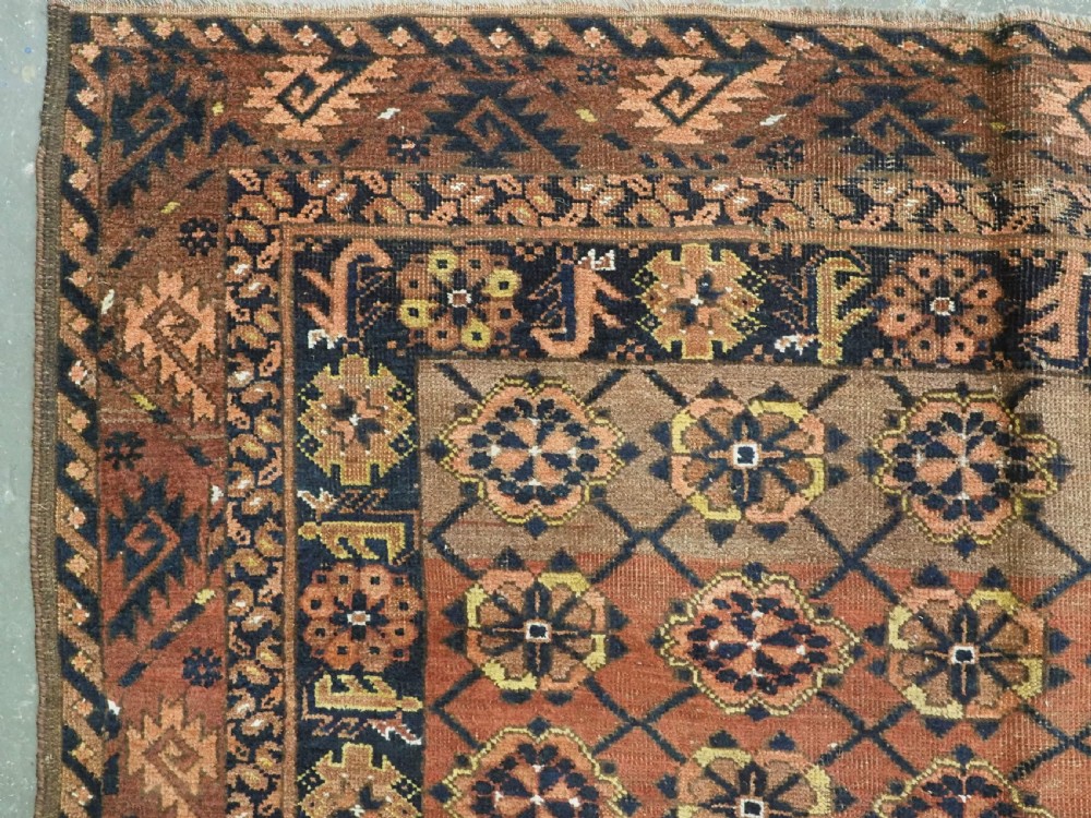 An antique Afghan Ersari Turkmen hand-knotted wool carpet featuring a repeating lattice grid with rosettes in terracotta red, dark blue, and yellow accents. View VI