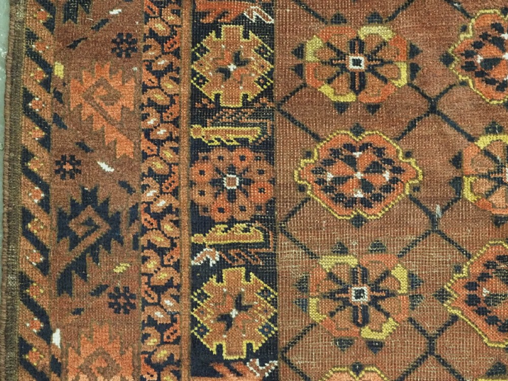 An antique Afghan Ersari Turkmen hand-knotted wool carpet featuring a repeating lattice grid with rosettes in terracotta red, dark blue, and yellow accents. View VII