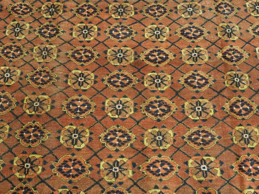 An antique Afghan Ersari Turkmen hand-knotted wool carpet featuring a repeating lattice grid with rosettes in terracotta red, dark blue, and yellow accents. View VIII