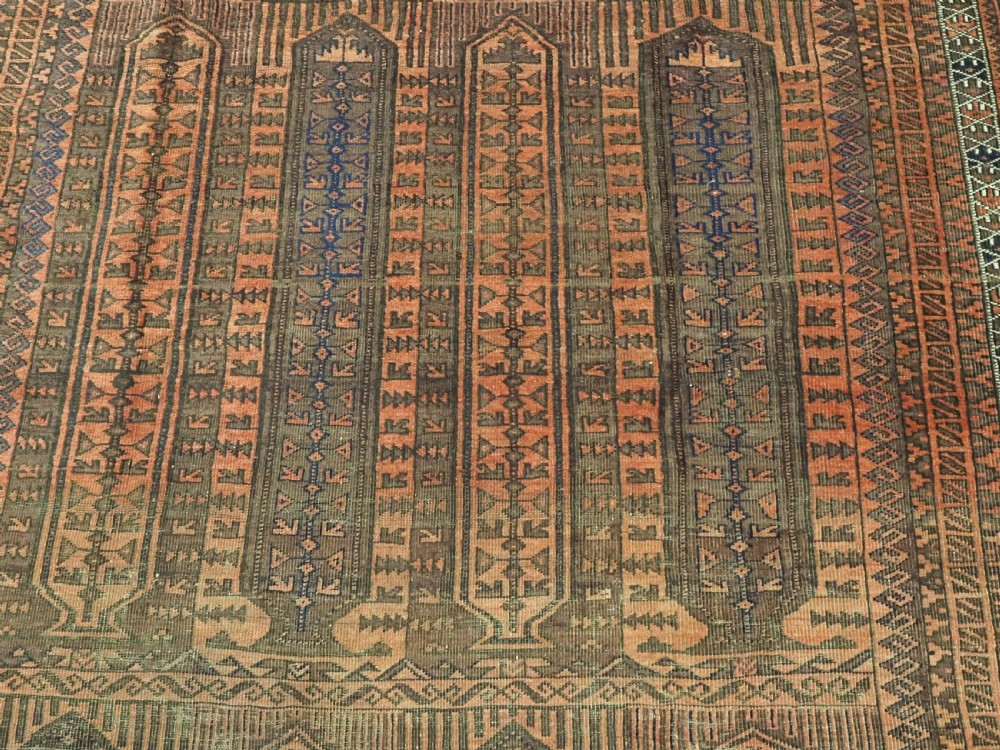 An antique Afghan Baluch hand-knotted wool carpet featuring repeating vertical geometric motifs in terracotta, dark brown, and rust tones. View IX