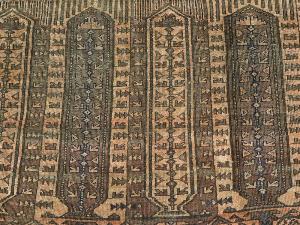 An antique Afghan Baluch hand-knotted wool carpet featuring repeating vertical geometric motifs in terracotta, dark brown, and rust tones. View XI