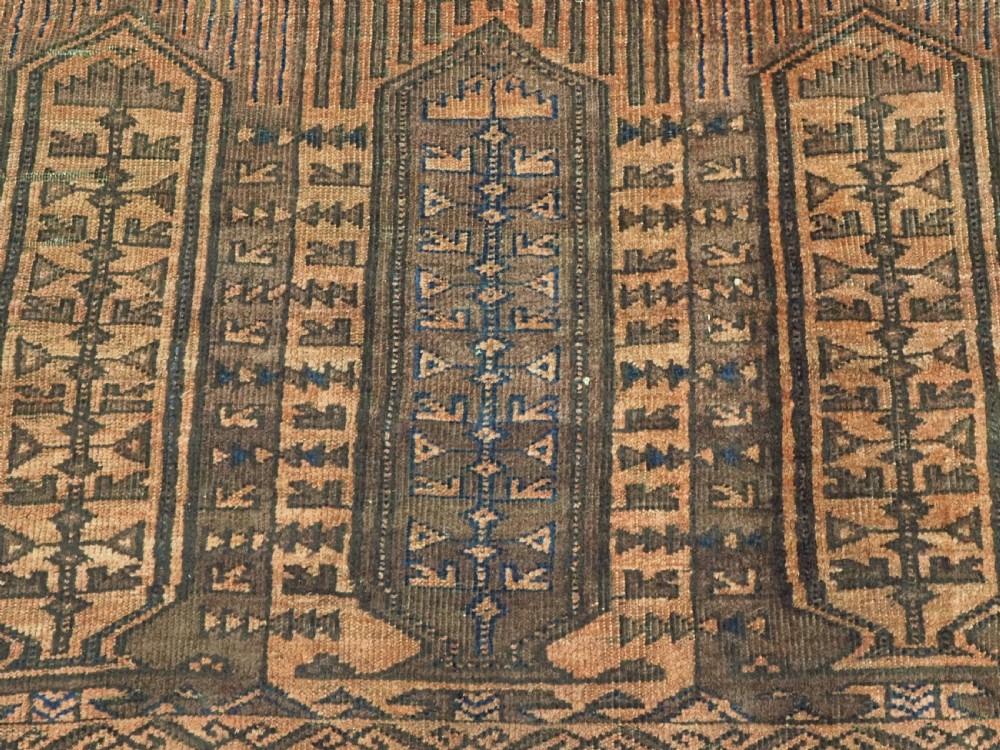 An antique Afghan Baluch hand-knotted wool carpet featuring repeating vertical geometric motifs in terracotta, dark brown, and rust tones. View XII