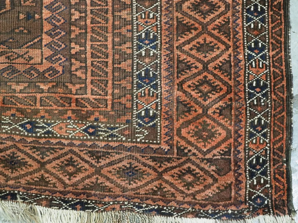 An antique Afghan Baluch hand-knotted wool carpet featuring repeating vertical geometric motifs in terracotta, dark brown, and rust tones. View XIII