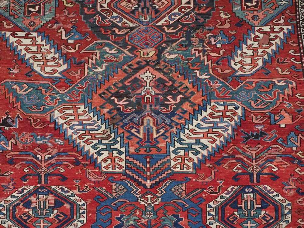 An antique hand-woven Caucasian Soumak flatweave rug featuring a red ground with geometric dragon medallions and a patterned border. View VIII