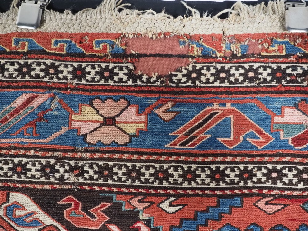 An antique hand-woven Caucasian Soumak flatweave rug featuring a red ground with geometric dragon medallions and a patterned border. View XVIII
