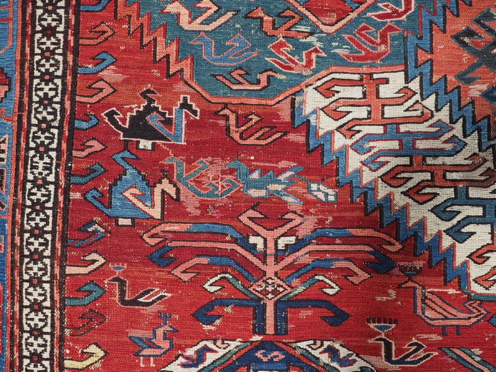 An antique hand-woven Caucasian Soumak flatweave rug featuring a red ground with geometric dragon medallions and a patterned border. View XXIII