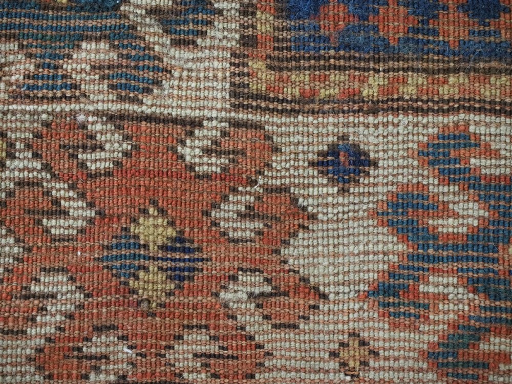 An antique Caucasian Kazak hand-knotted long rug featuring four geometric medallions along a central teal blue field within a decorated ivory border. View XV