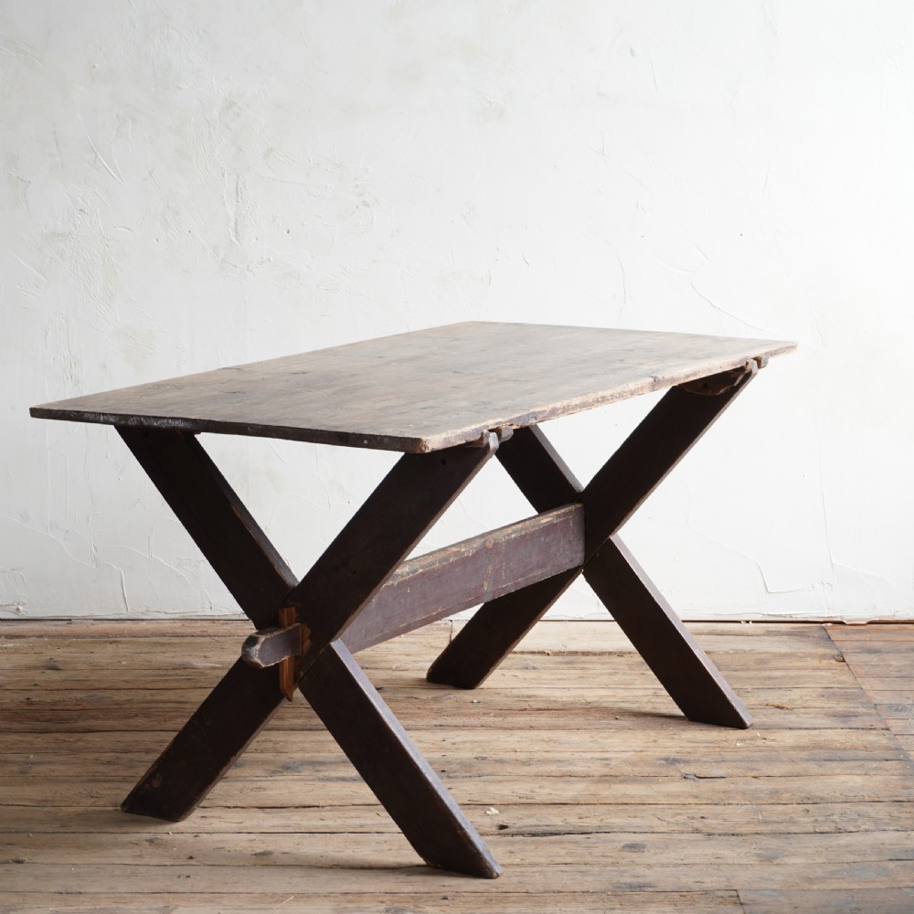 A rustic dark timber tavern table featuring an X-frame trestle base connected by a central horizontal stretcher. View III