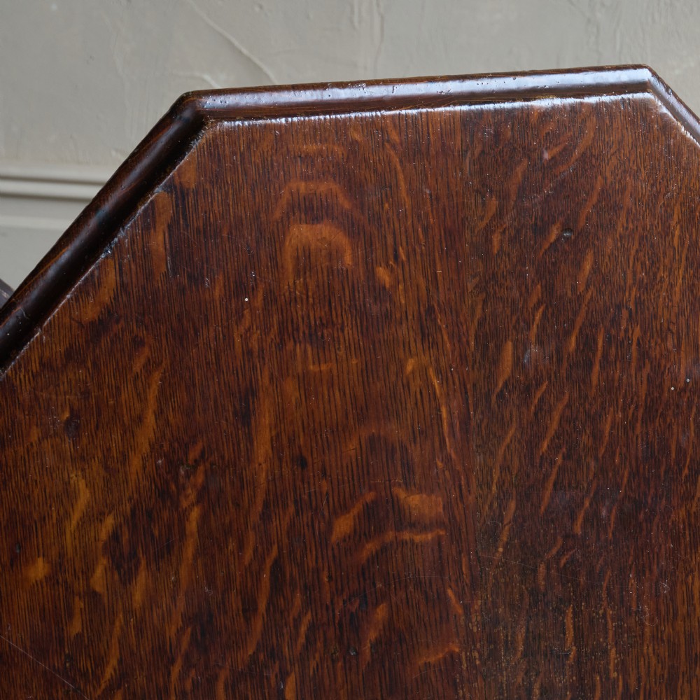 An octagonal Victorian walnut side table featuring turned legs, a lower tier shelf, and brass castors on curved feet. View VI