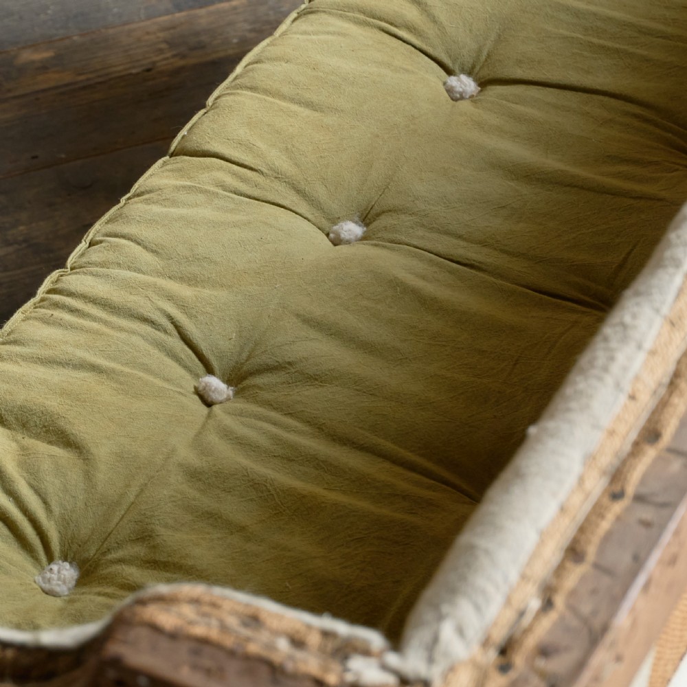 An antique Georgian square-back sofa featuring exposed wooden framing, eight legs with castors, and a yellow tufted seat cushion. View VIII