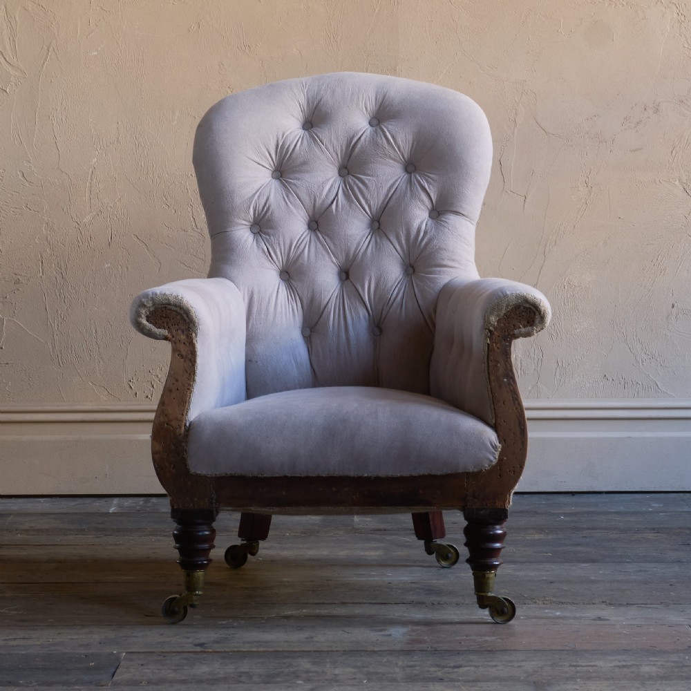 A Regency period button-backed armchair upholstered in pale grey fabric with lyre-shaped front arm supports and turned mahogany legs on brass castors. View III