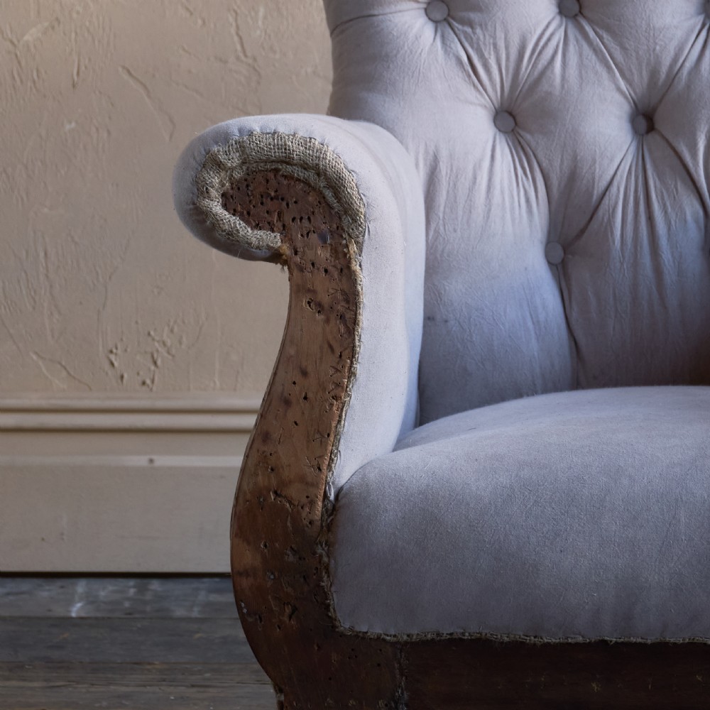 A Regency period button-backed armchair upholstered in pale grey fabric with lyre-shaped front arm supports and turned mahogany legs on brass castors. View VIII
