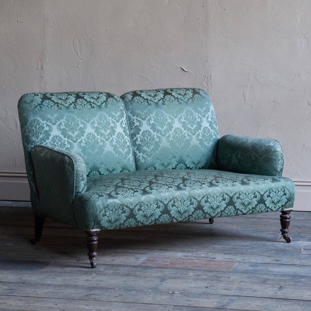 Antique bedroom sofa in green damask