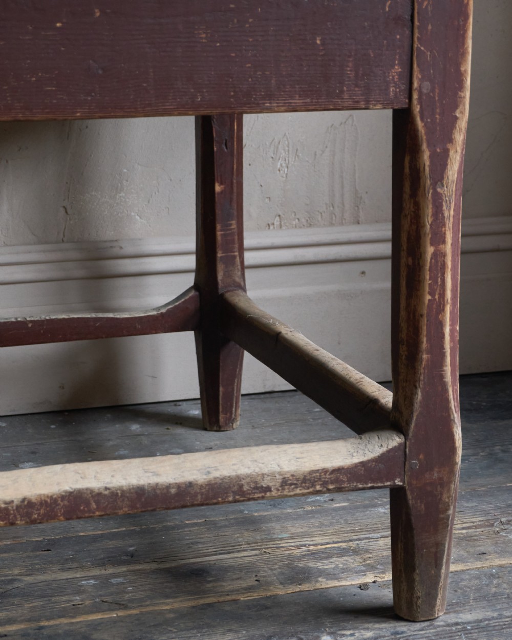 An antique Swedish kitchen table featuring an untreated scrubbed pine top, a single side drawer, and a Falu red painted apron and leg framework with stretchers. View XII