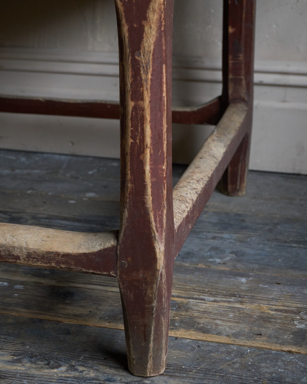 An antique Swedish kitchen table featuring an untreated scrubbed pine top, a single side drawer, and a Falu red painted apron and leg framework with stretchers. View XIII