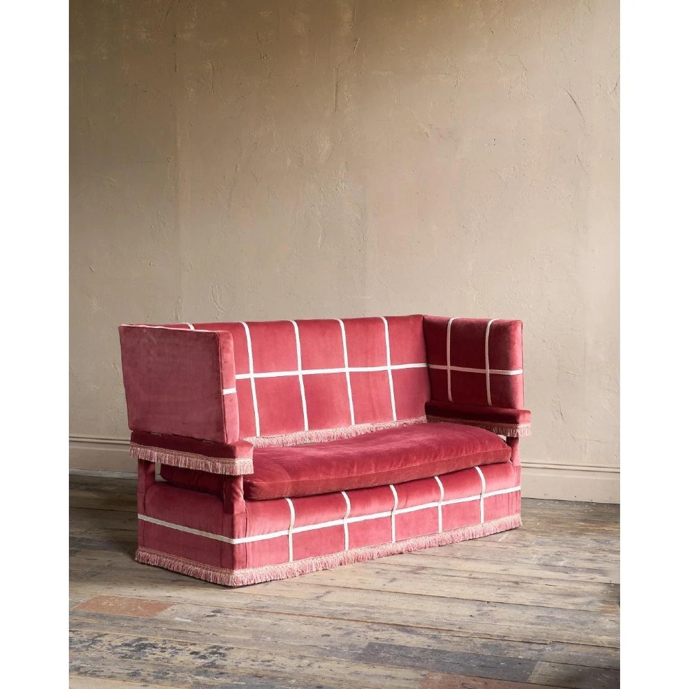 A claret red velvet Knole sofa featuring grid pattern braid trim, fringe edging, and adjustable drop-down armrests with metal ratchets. View II