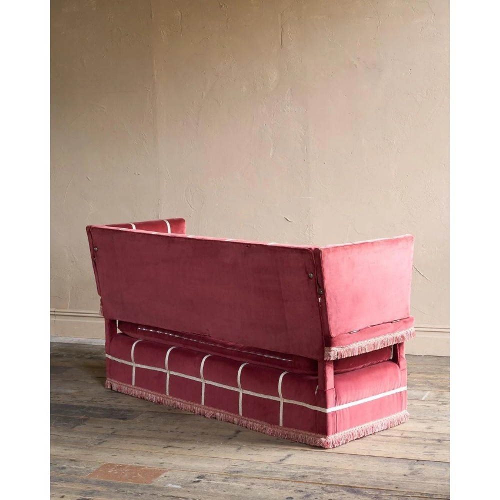 A claret red velvet Knole sofa featuring grid pattern braid trim, fringe edging, and adjustable drop-down armrests with metal ratchets. View X