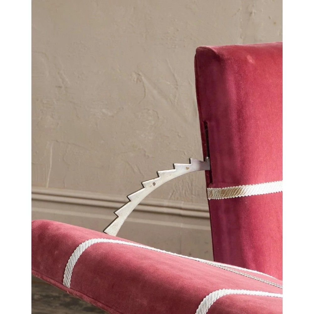 A claret red velvet Knole sofa featuring grid pattern braid trim, fringe edging, and adjustable drop-down armrests with metal ratchets. View XIV