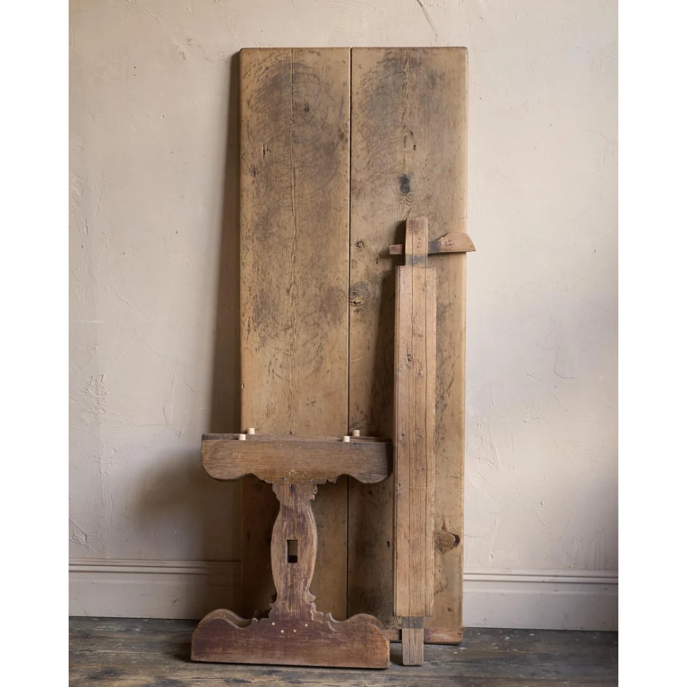 An 18th-century Swedish pine dining table featuring a rectangular plank top resting on a sculpted trestle base with a central stretcher. View III