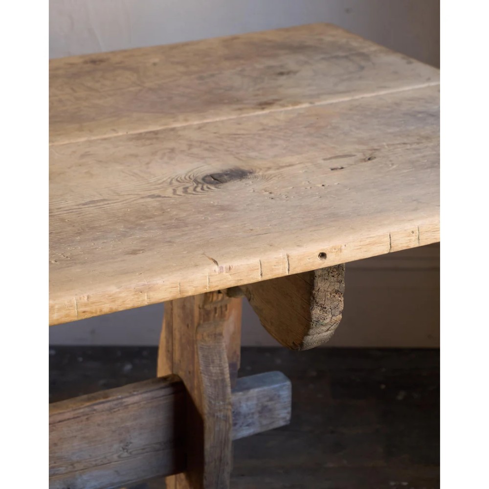 An 18th-century Swedish pine dining table featuring a rectangular plank top resting on a sculpted trestle base with a central stretcher. View VIII
