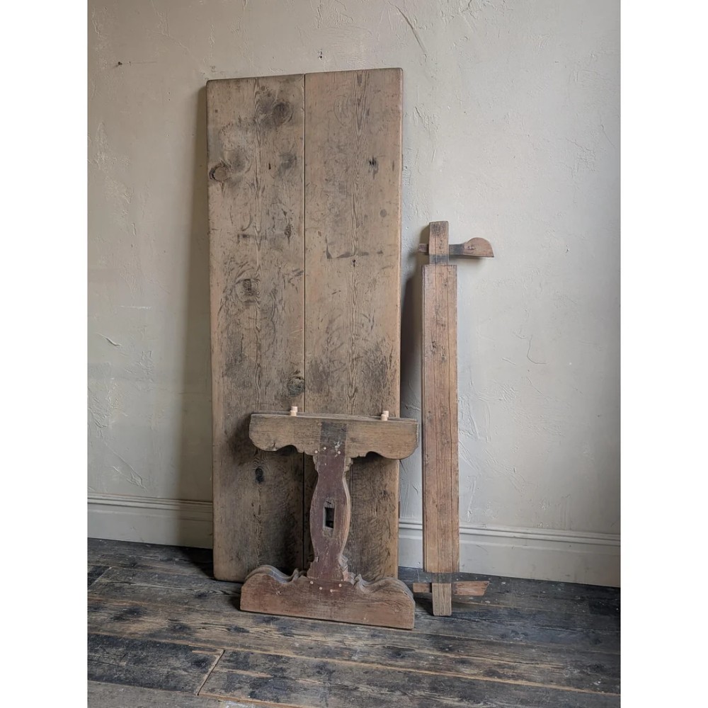 An 18th-century Swedish pine dining table featuring a rectangular plank top resting on a sculpted trestle base with a central stretcher. View XIV
