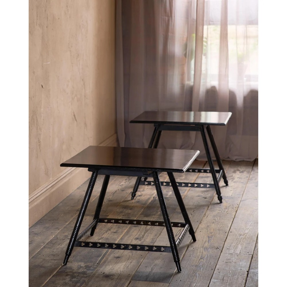 A matched pair of square ebonised wooden side tables with splayed turned legs and decorative pierced lower stretchers. View II