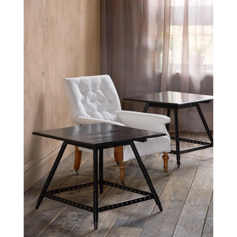 A matched pair of square ebonised wooden side tables with splayed turned legs and decorative pierced lower stretchers. View IV