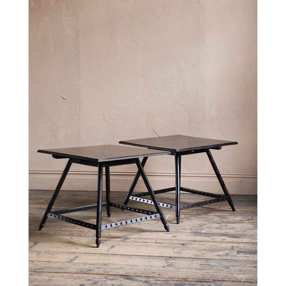 A matched pair of square ebonised wooden side tables with splayed turned legs and decorative pierced lower stretchers. View V